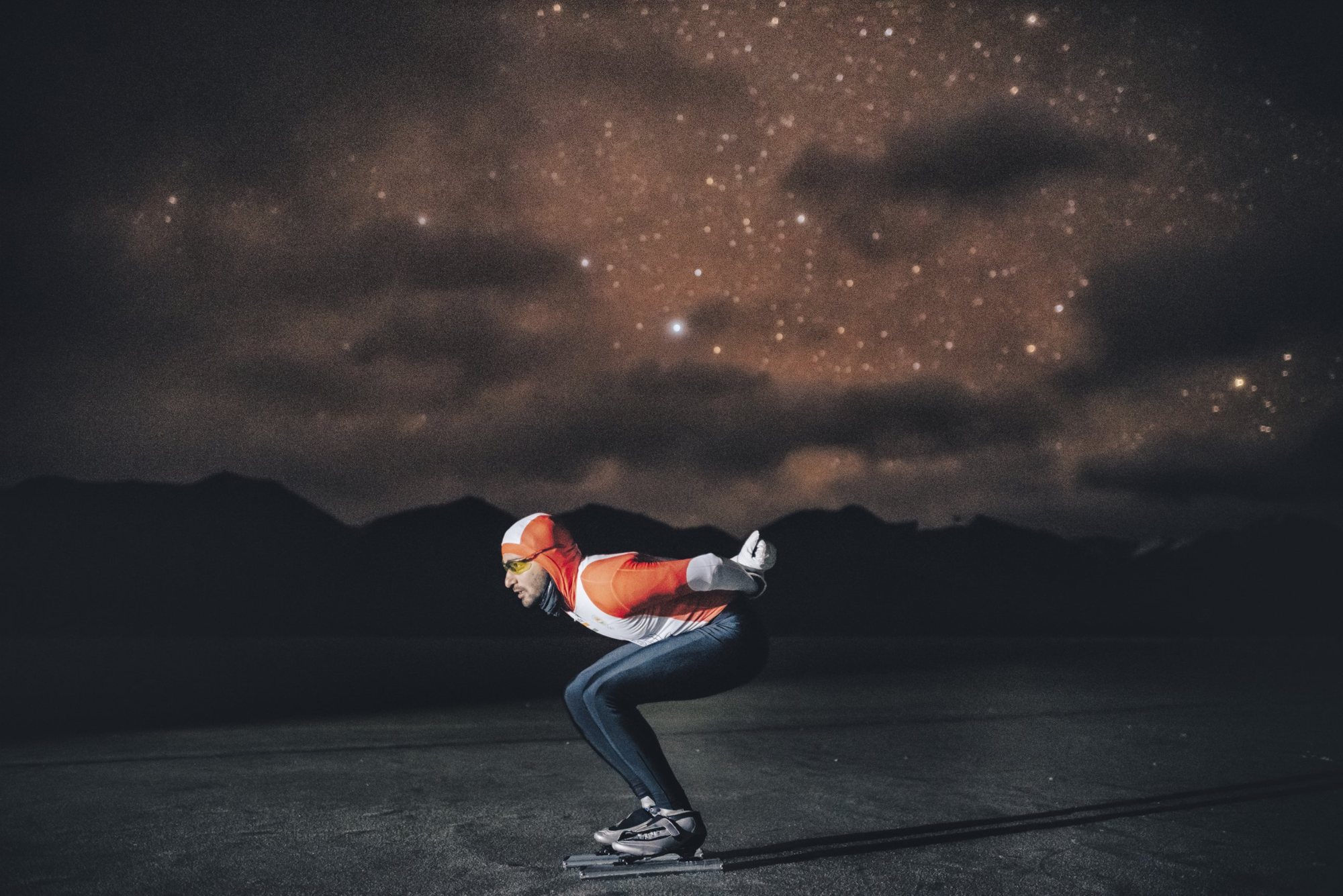 Vishwaraj Jadeja in a full tuck on Pangong Tso at night, stars over the Ladakh mountains