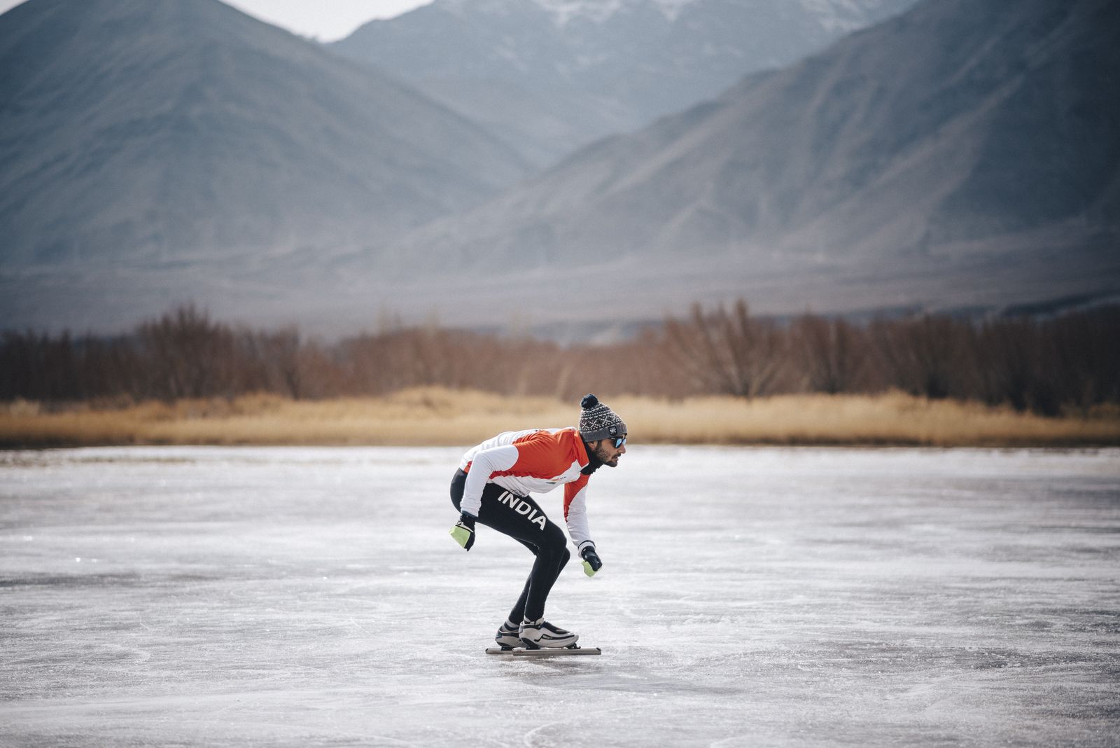 Vishwaraj skating on a frozen lake in Ladakh with the Himalayas behind — the On Thin Ice Club training ground