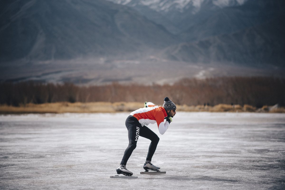Skating a frozen lake in Ladakh, blades on the ice, mountains behind
