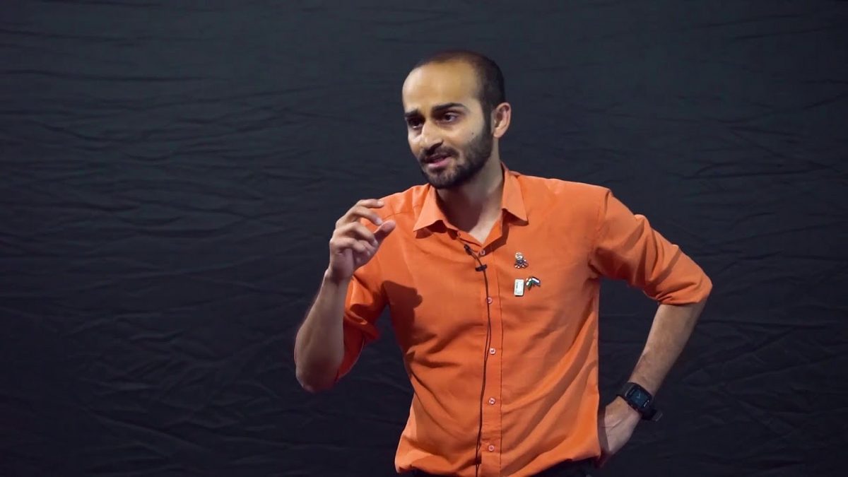 Vishwaraj speaking on the TEDx stage in 2018